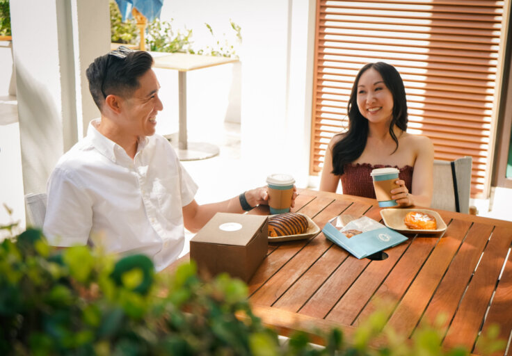 man and woman eating pastries